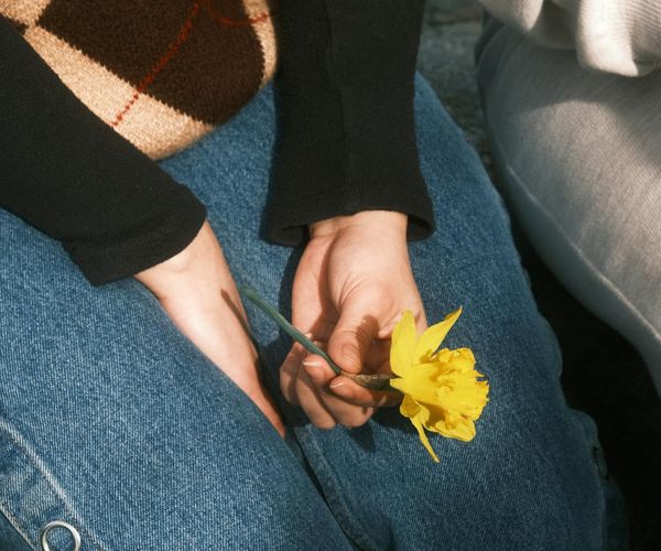 Close-up of a person's hands in a meditative gesture.